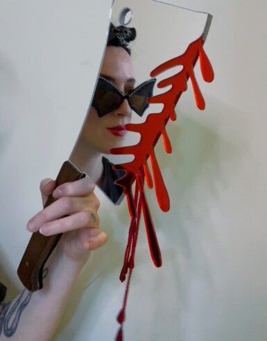 Ambush Blood Test
2025
14" long. The blade is 7.5" long and 5" wide. Including the blood drips – both beaded and acrylic – the height of the piece hanging at the right angle is 13.5"
Acrylic mirror, walnut, brass, thread, beads, paint, pine Ambush Blood Test